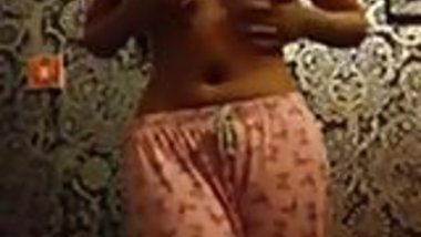 Skinny Indian woman strips in her bedroom. 