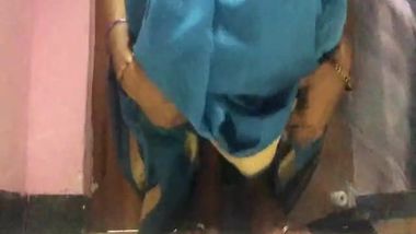 Amateur porn video where Desi MILF lifts blue dress to play with pussy