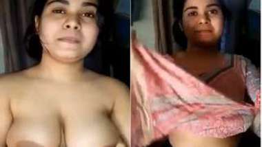 Indian slut sits in front of camera happily baring saggy XXX boobs