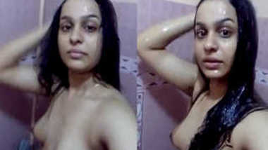 Indian girl expose XXX charms in the shower holding sex camera in hand