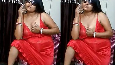 Hot Desi aunty seductively smokes being dressed in red XXX lingerie