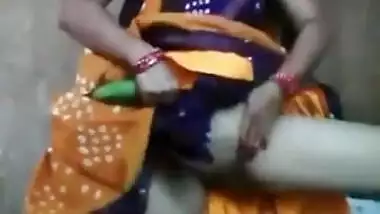 Innocent looking aunty playing with cucumber