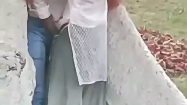 College couple enjoys outdoor sex below a big tree